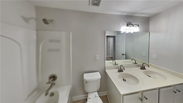 bathroom with toilet, shower / bathtub combination, double vanity, and a sink