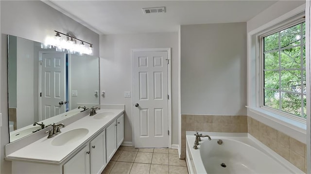 bathroom featuring visible vents, a bath, tile patterned flooring, and a sink