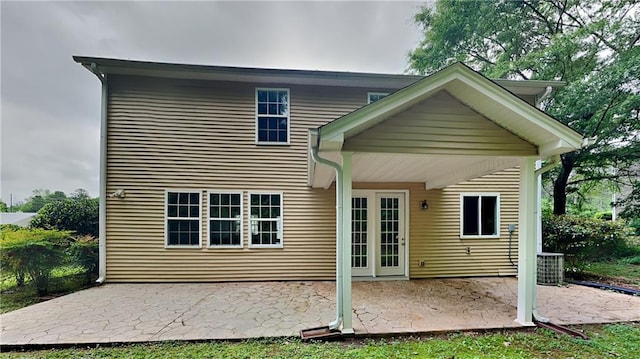 rear view of property with central air condition unit and a patio area