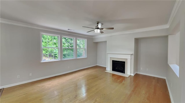 unfurnished living room with baseboards, ornamental molding, and ceiling fan
