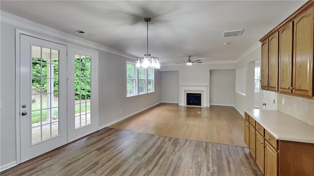 unfurnished living room with a fireplace, visible vents, light wood-style flooring, and baseboards