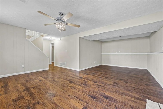 interior space with dark hardwood / wood-style flooring, ceiling fan, and a textured ceiling