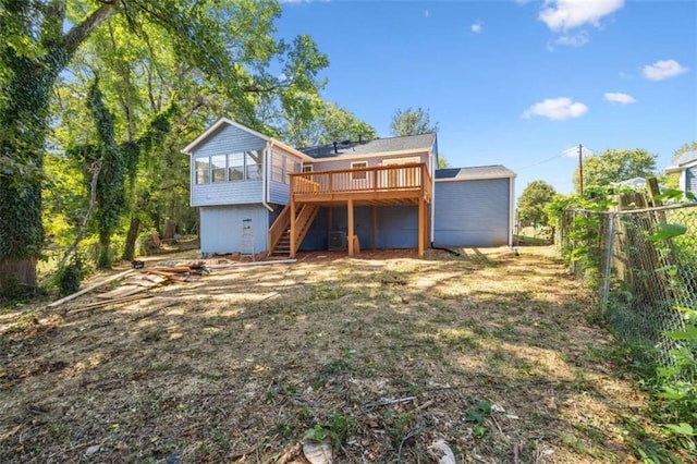 rear view of property with a wooden deck