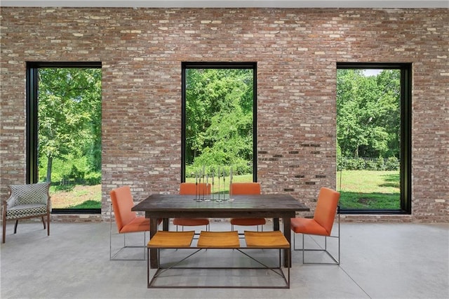 538 Main St, Palmetto, GA 30268 - dining area featuring plenty of natural light, brick wall, and concrete flooring