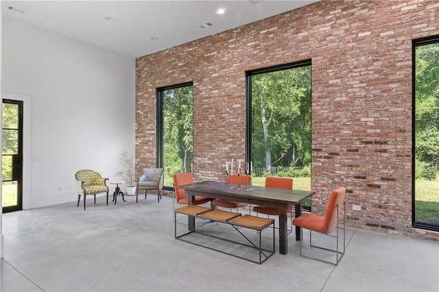 538 Main St, Palmetto, GA 30268 - dining area featuring finished concrete flooring and brick wall