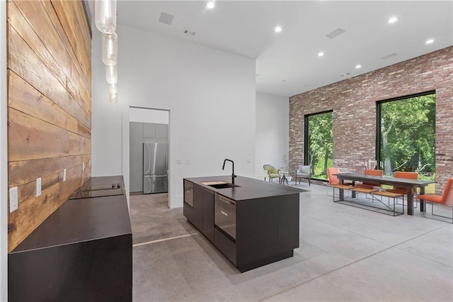 538 Main St, Palmetto, GA 30268 - kitchen with stainless steel fridge, modern cabinets, a high ceiling, finished concrete flooring, and an island with sink