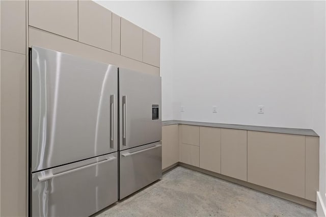 538 Main St, Palmetto, GA 30268 - kitchen with high end fridge, finished concrete floors, cream cabinets, and light countertops