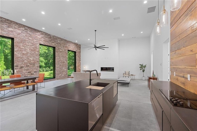 538 Main St, Palmetto, GA 30268 - kitchen featuring modern cabinets, open floor plan, concrete flooring, ceiling fan, and hanging light fixtures