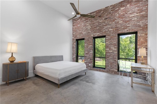538 Main St, Palmetto, GA 30268 - bedroom featuring finished concrete floors, a towering ceiling, and brick wall
