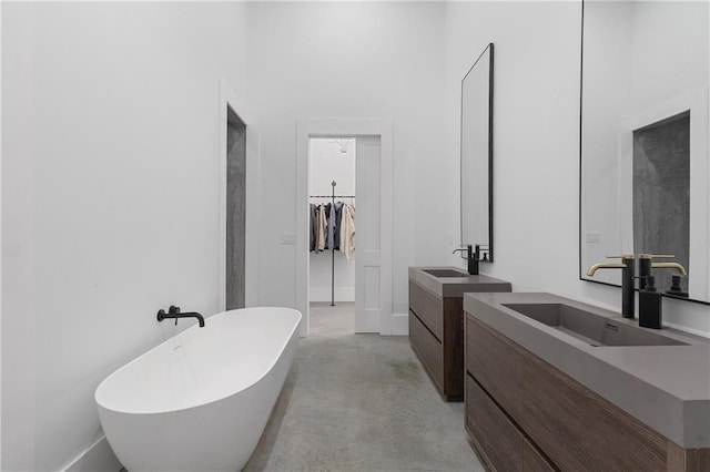 538 Main St, Palmetto, GA 30268 - bathroom with two vanities, a freestanding bath, and concrete floors