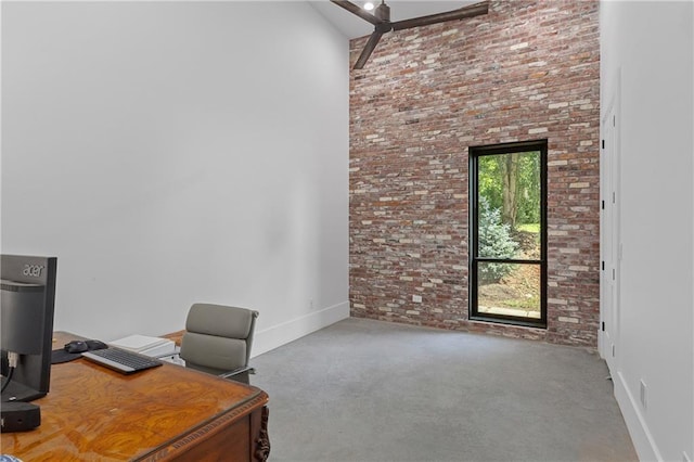 538 Main St, Palmetto, GA 30268 - carpeted home office featuring brick wall and a towering ceiling