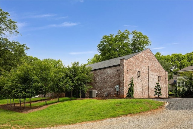 538 Main St, Palmetto, GA 30268 - view of home's exterior with a yard, brick siding, and gravel driveway