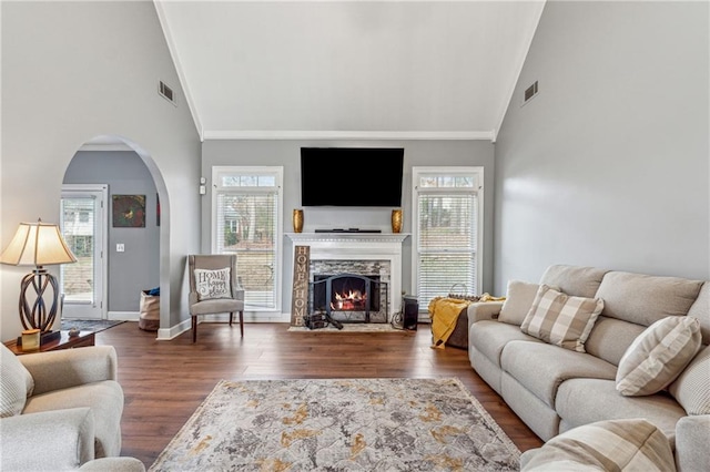 3207 Haleys Way, Conyers, GA 30013 - living area with arched walkways, crown molding, wood finished floors, healthy amount of natural light, and high vaulted ceiling