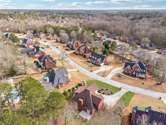 aerial view of residential area featuring a heavily wooded area