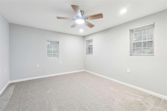 carpeted spare room featuring recessed lighting, baseboards, and ceiling fan