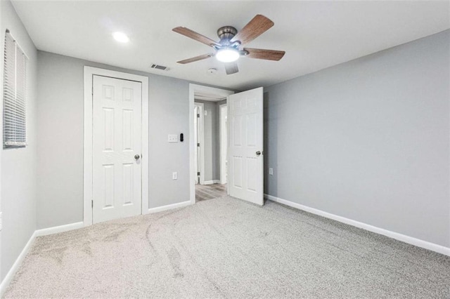 unfurnished bedroom featuring visible vents, baseboards, ceiling fan, and carpet flooring