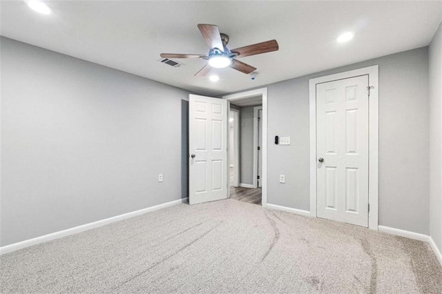 unfurnished bedroom featuring recessed lighting, visible vents, carpet flooring, and baseboards