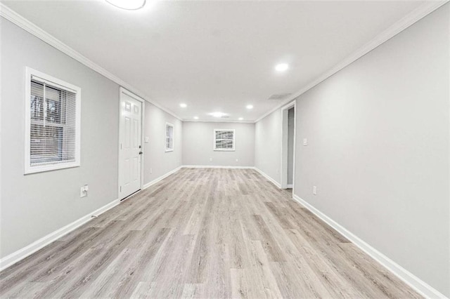 empty room with crown molding, light wood-style flooring, recessed lighting, and baseboards