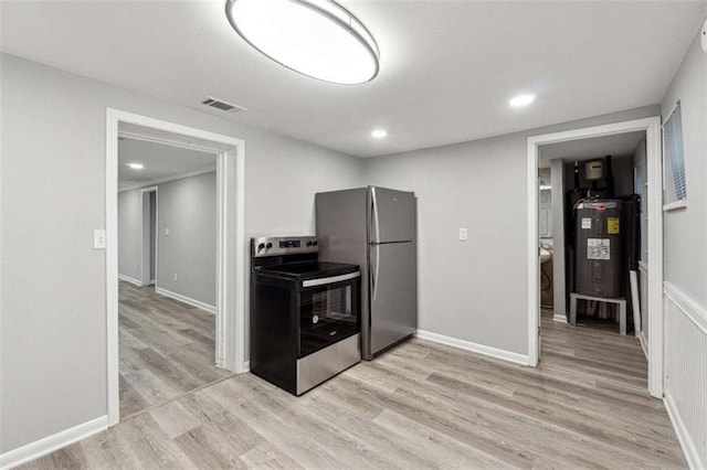 kitchen with stainless steel appliances, visible vents, water heater, and light wood finished floors