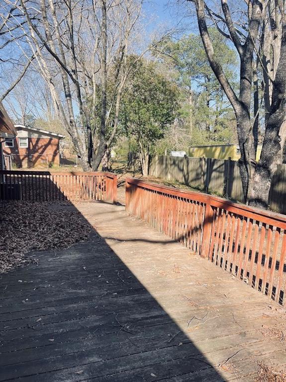 view of yard featuring fence and a wooden deck