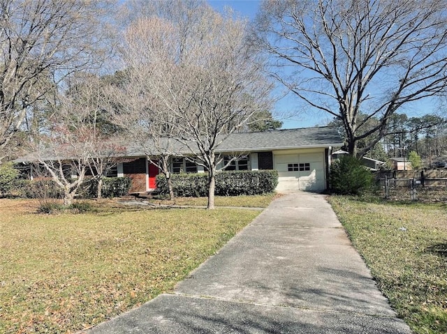 single story home featuring a garage, concrete driveway, a front yard, and fence