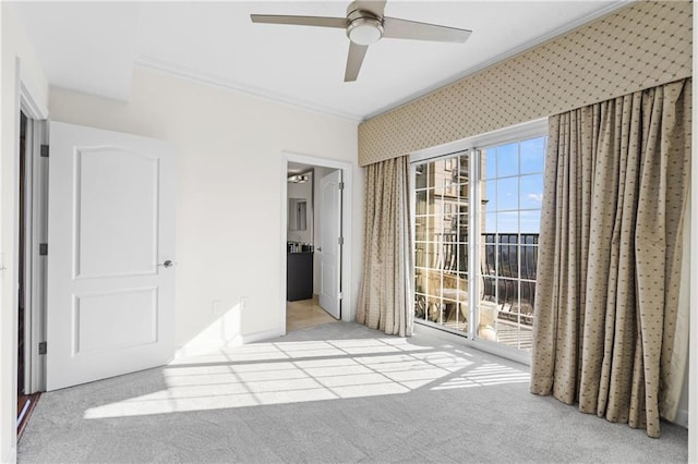 unfurnished bedroom with access to exterior, connected bathroom, crown molding, ceiling fan, and carpet