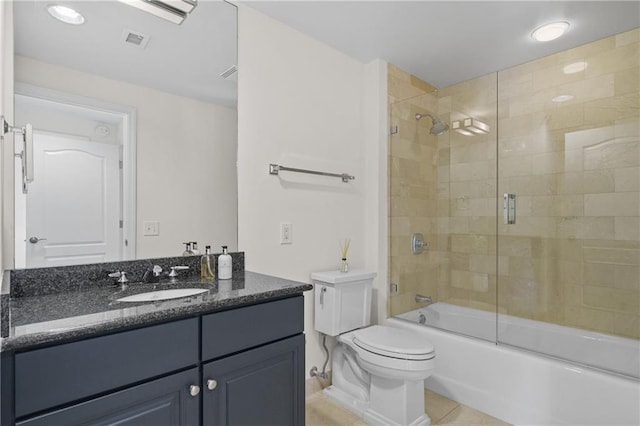 bathroom featuring vanity, visible vents, tile patterned floors, toilet, and combined bath / shower with glass door