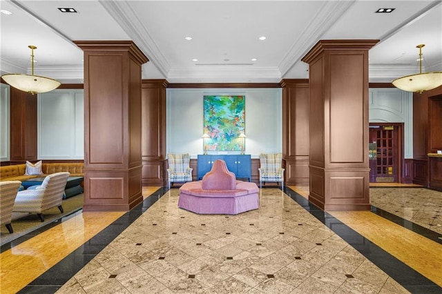 living area featuring crown molding, a decorative wall, decorative columns, and recessed lighting