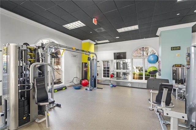 workout area with a drop ceiling and ornamental molding