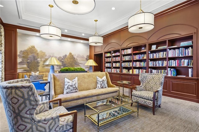 sitting room with carpet flooring, recessed lighting, built in shelves, and crown molding