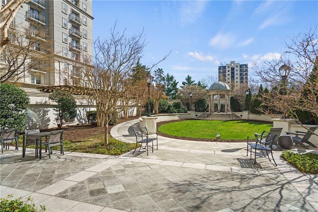 view of community with a patio area and a lawn