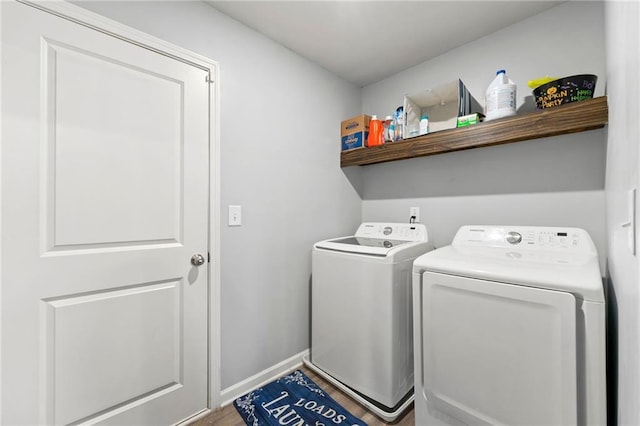 washroom with separate washer and dryer and hardwood / wood-style floors