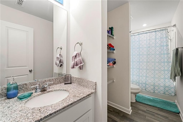 bathroom with hardwood / wood-style floors, vanity, and toilet