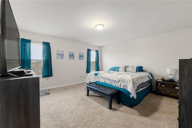 carpeted bedroom featuring multiple windows