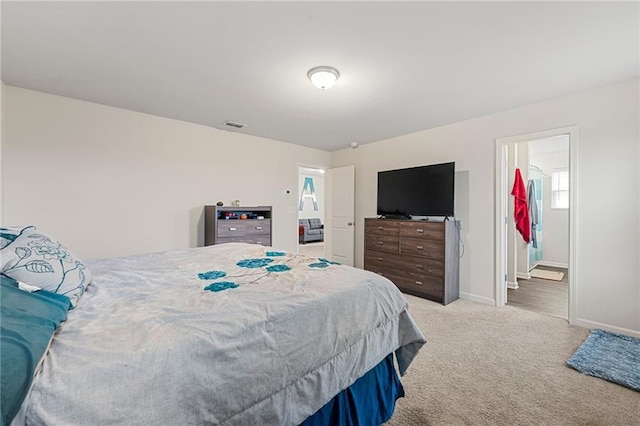 carpeted bedroom with connected bathroom