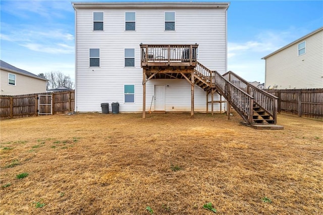 back of property featuring a yard and a deck