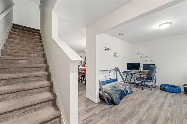 staircase featuring wood-type flooring