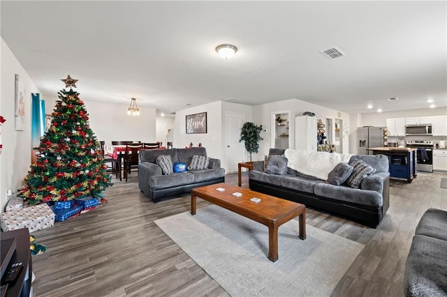 living room featuring hardwood / wood-style floors and an inviting chandelier