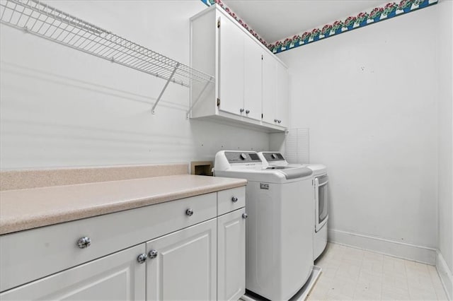 washroom featuring cabinets and washer and dryer