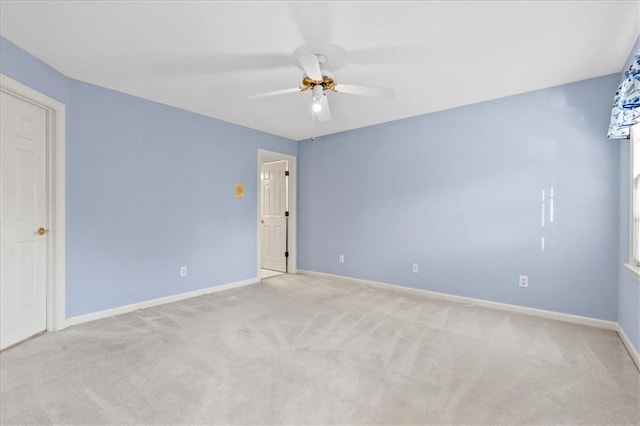 carpeted spare room with ceiling fan