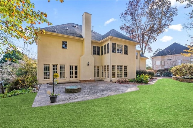 back of property featuring a yard, a patio, and french doors