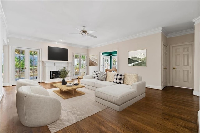 living room featuring ceiling fan, dark hardwood / wood-style flooring, and ornamental molding