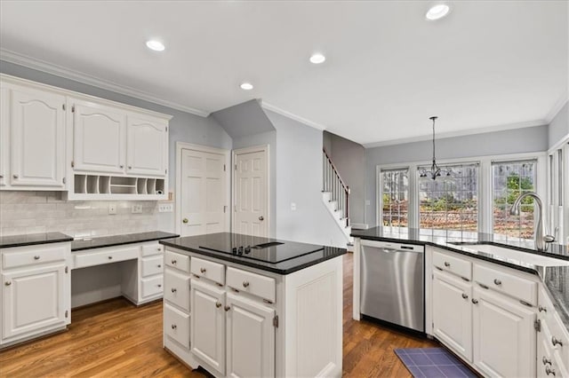 kitchen with sink, white cabinets, stainless steel dishwasher, and wood-type flooring