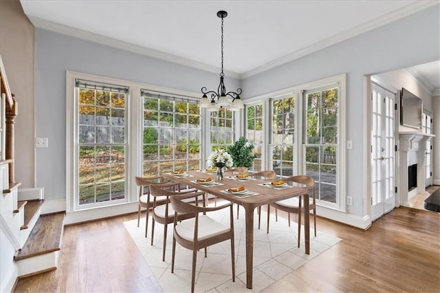 dining area featuring plenty of natural light, hardwood / wood-style floors, and ornamental molding