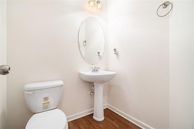 bathroom with hardwood / wood-style floors and toilet