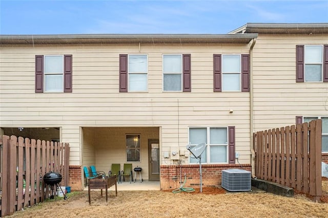 rear view of property with a patio and central air condition unit