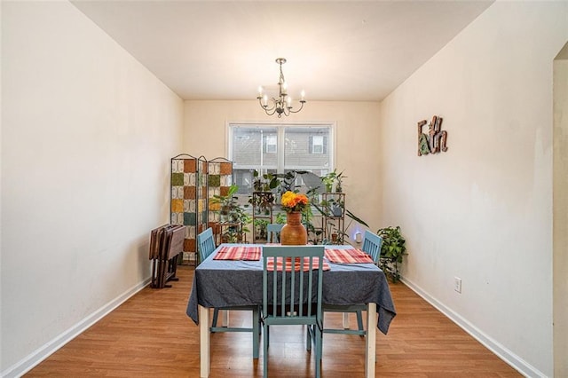 dining room featuring hardwood / wood-style flooring and a chandelier