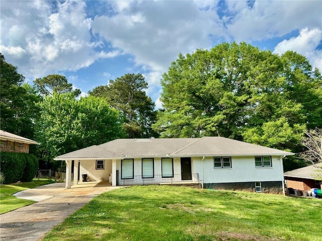 ranch-style house with driveway and a front lawn