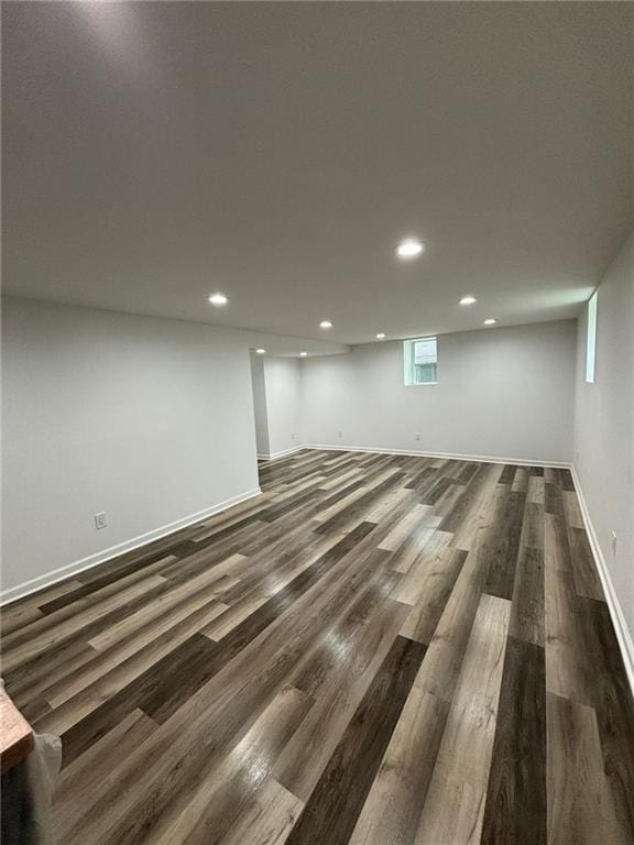 basement with recessed lighting, baseboards, and dark wood-style floors