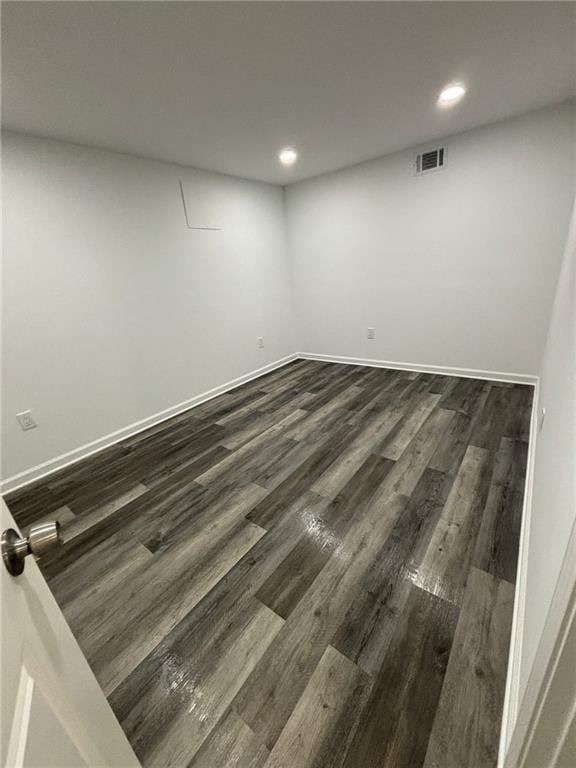 unfurnished room with visible vents, recessed lighting, dark wood-type flooring, and baseboards